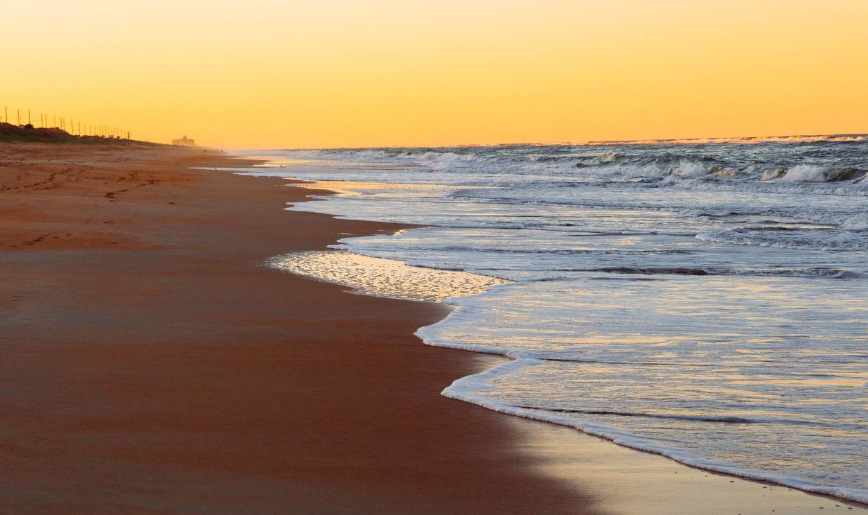 Experience tranquility with this serene sunset view at Ormond Beach, Florida's sandy coastline.