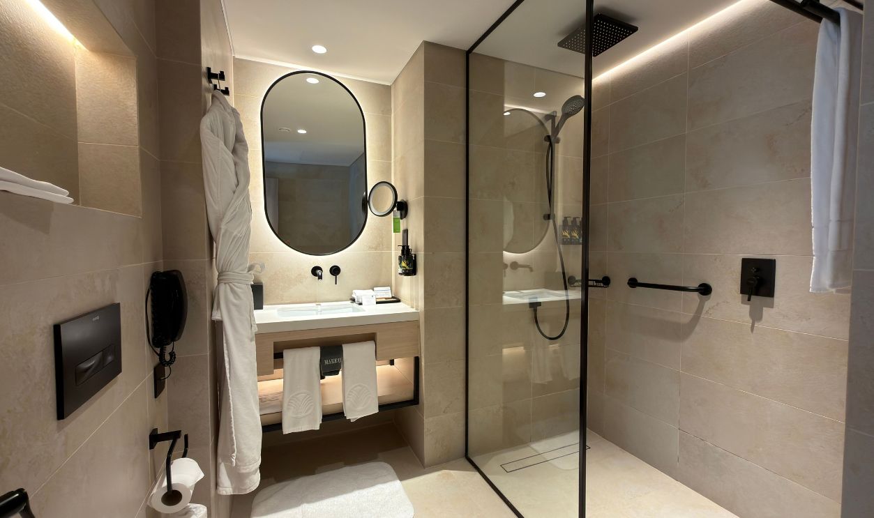 Luxurious hotel bathroom featuring a sleek shower and contemporary fixtures.