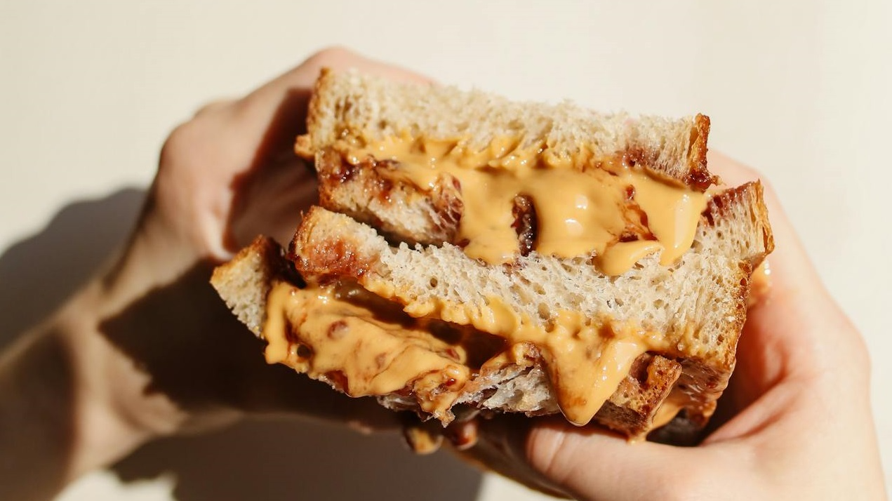 Person Holding Peanut butter sandwich.