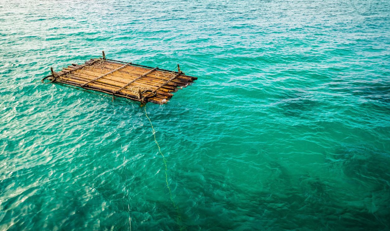 Bamboo raft is floating in a blue lagoon