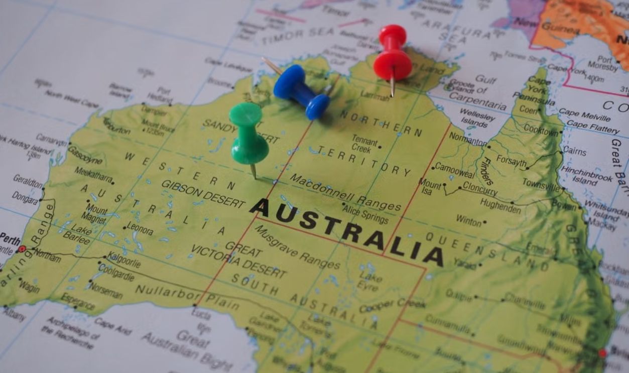 Close-up of a map of Australia featuring colorful pushpins marking locations