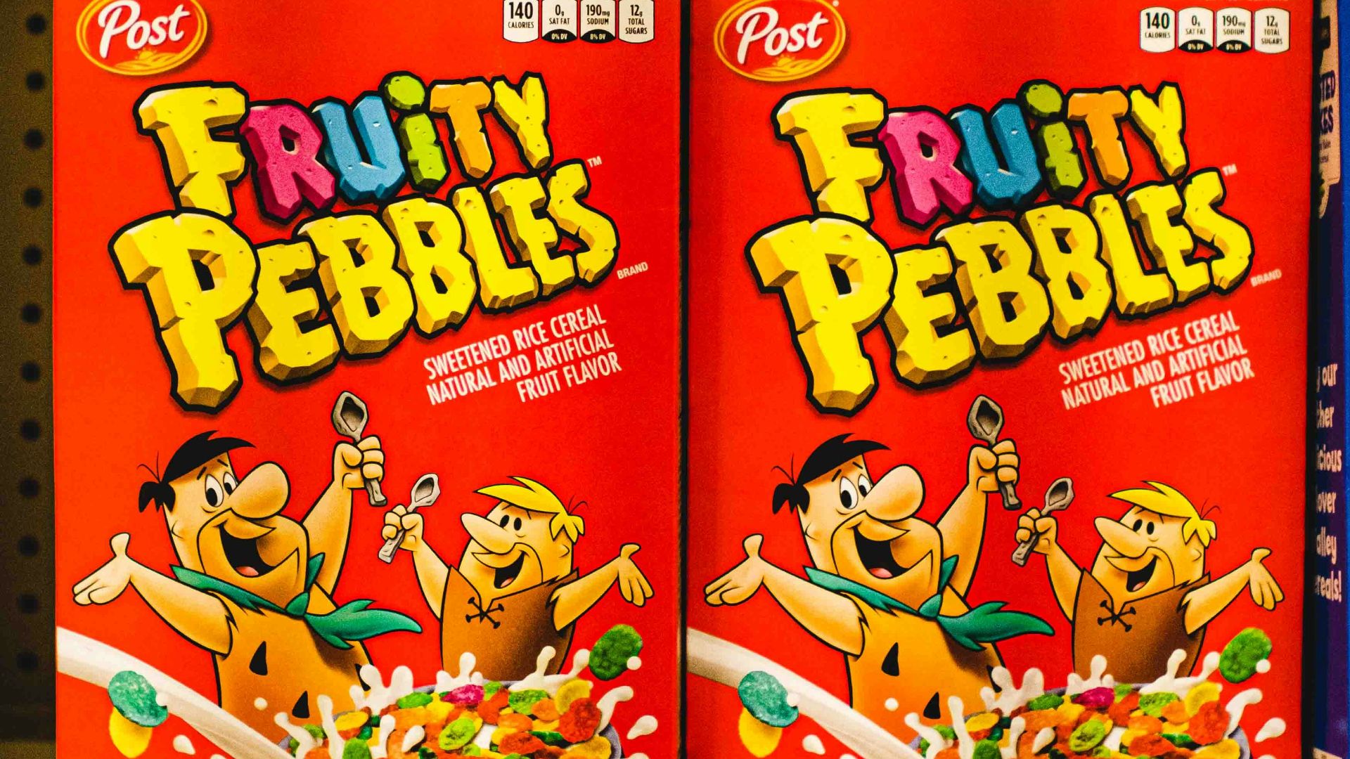 a row of cereal boxes sitting on top of a shelf