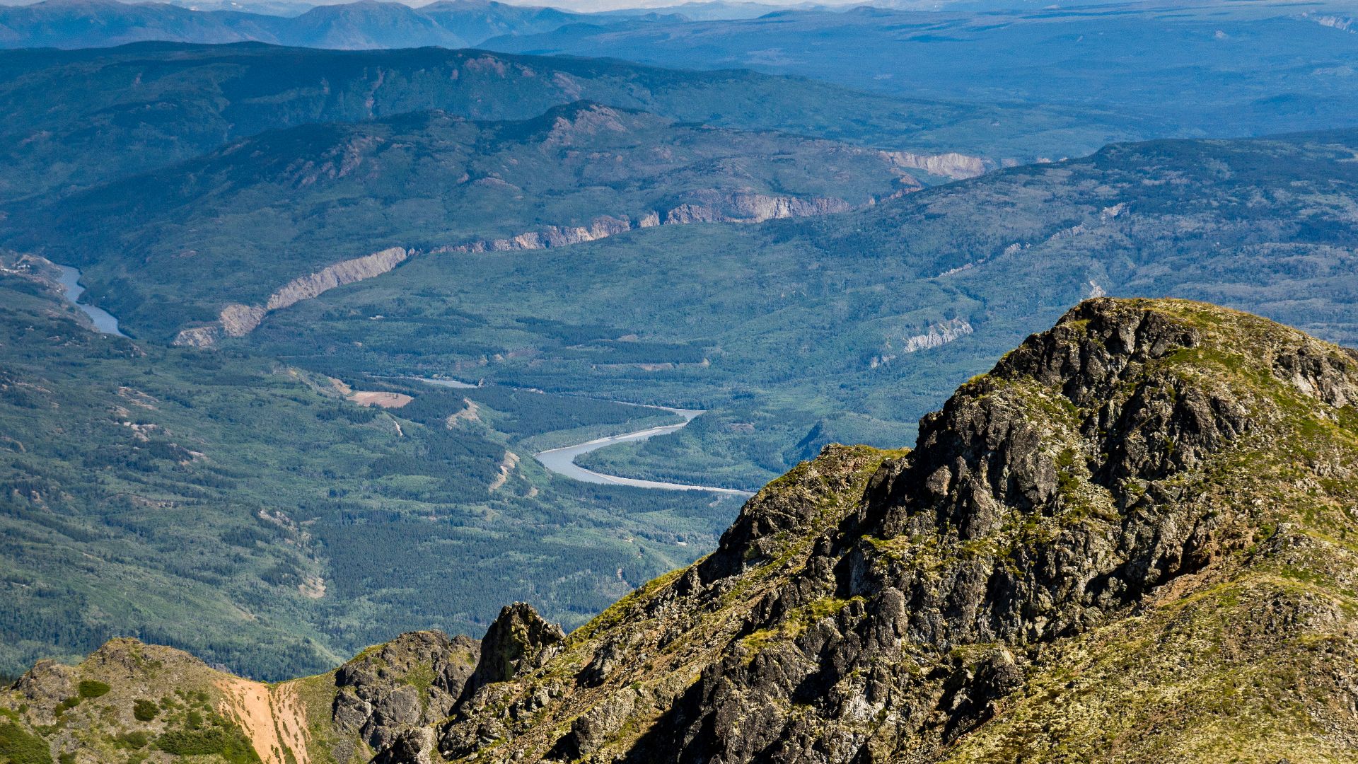 Mess Creek flows north-northwest through a narrow canyon before meeting the Stikine River (foreground) in the northwest corner of Mount Edziza Provincial Park. View from Mount Glenora, facing southeast.