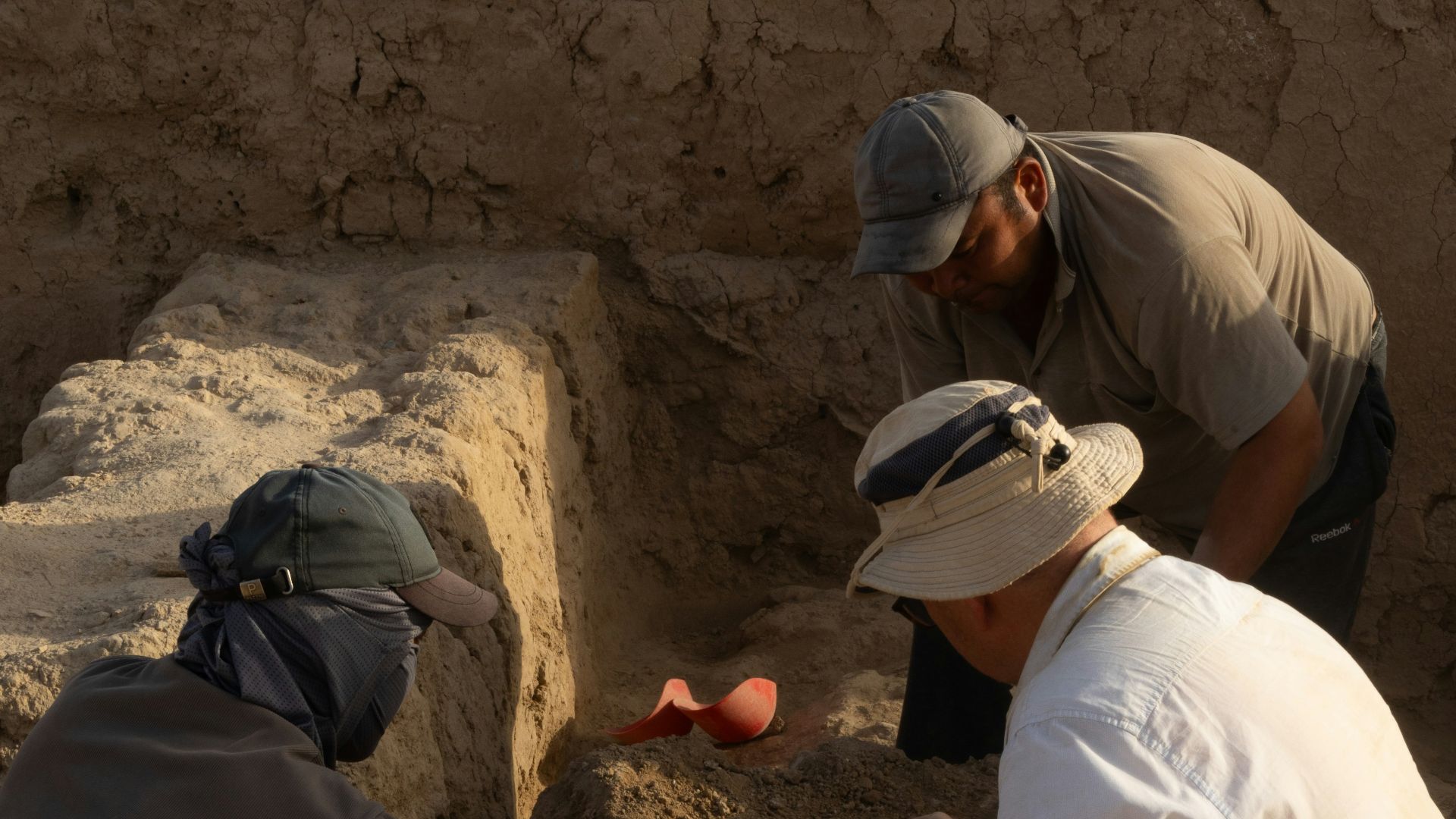 A group of men kneeling down next to each other