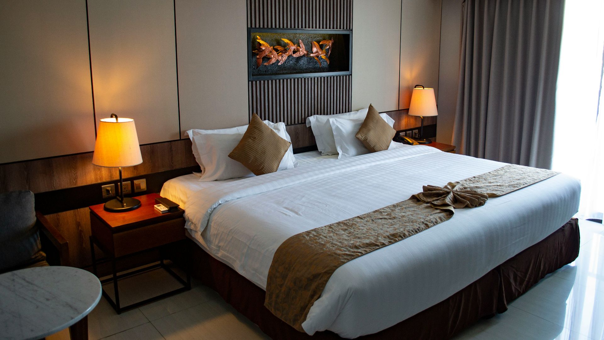 white bed linen with throw pillows