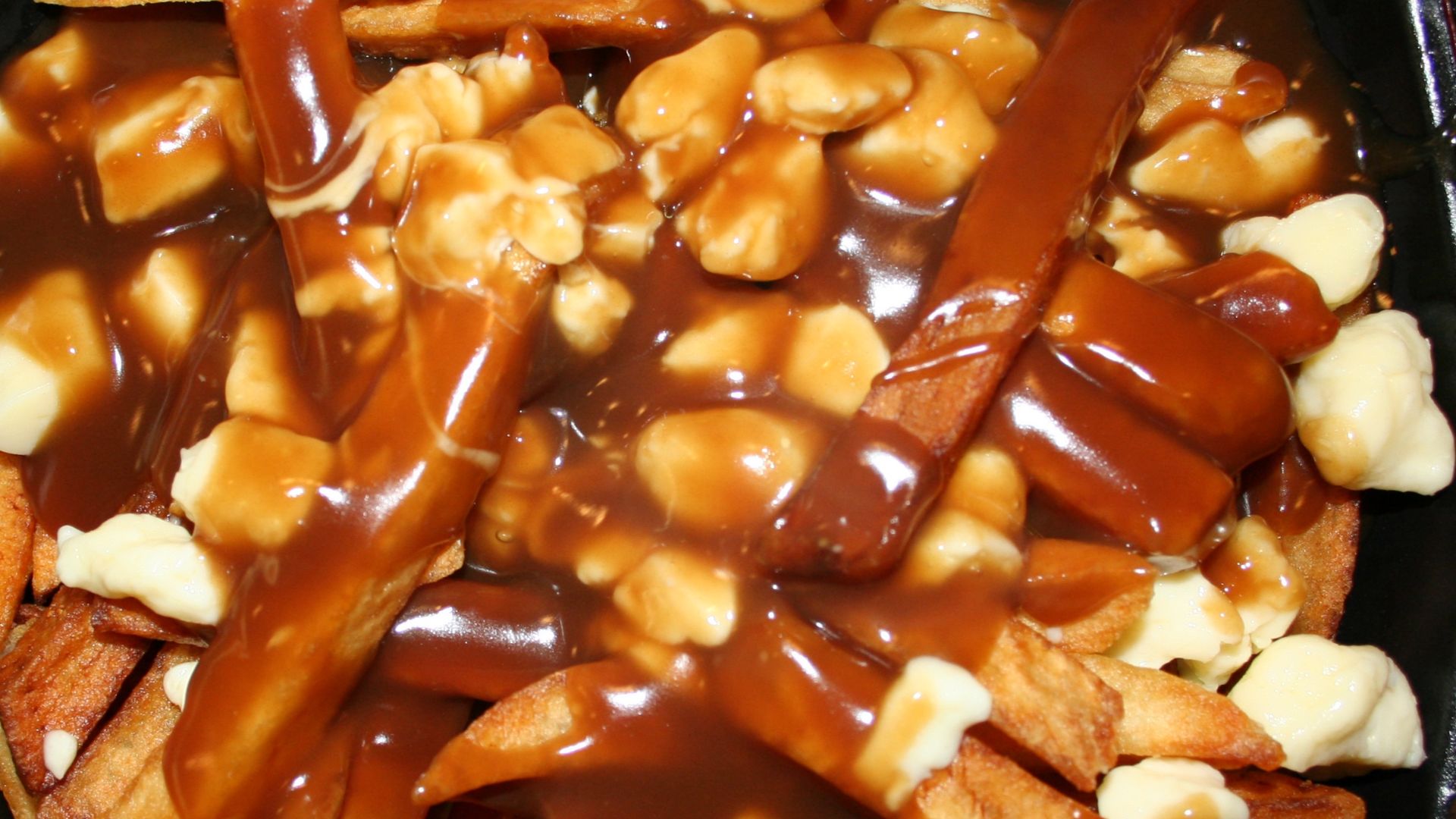 Poutine (French fried potatoes with cheese curds and beef gravy) as served at the Frit-O-Cheezz restaurant in Andover, Minnesota, United States