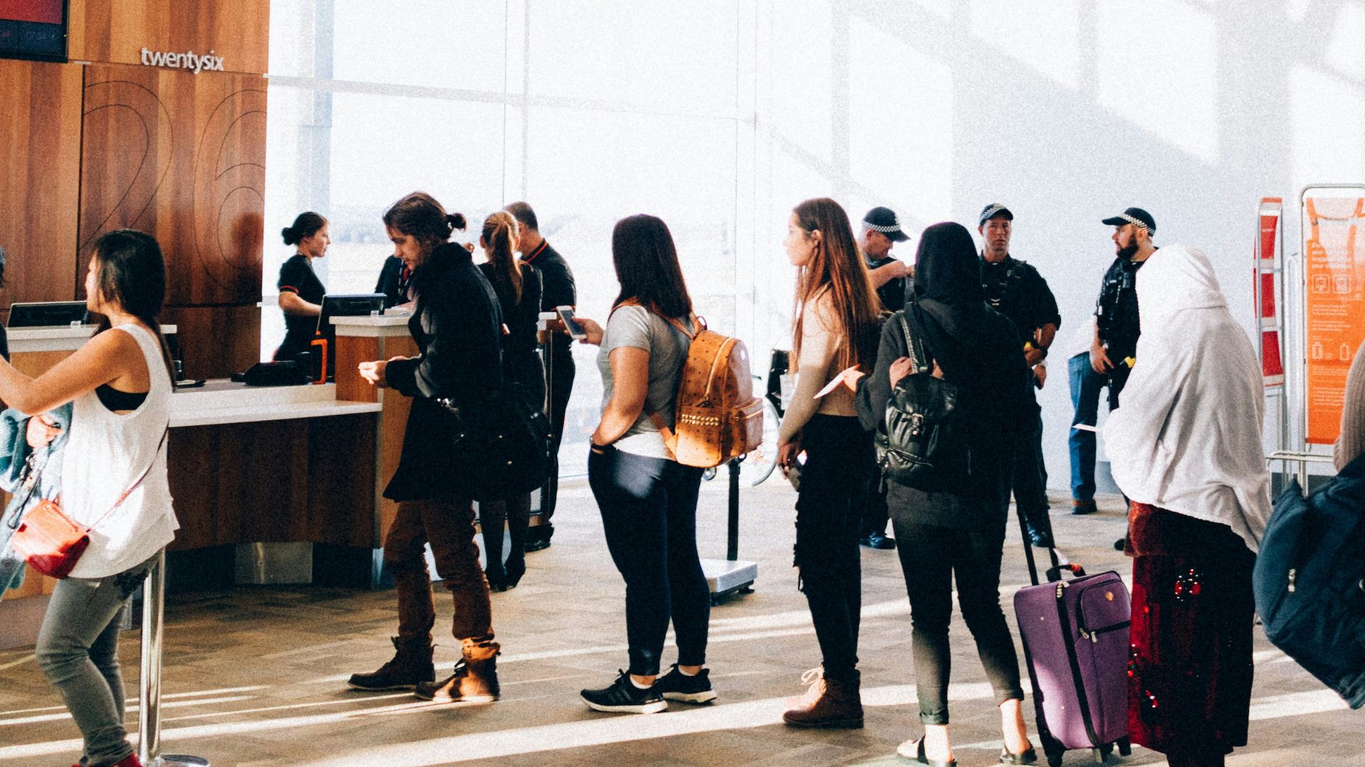 a group of people standing in a large room