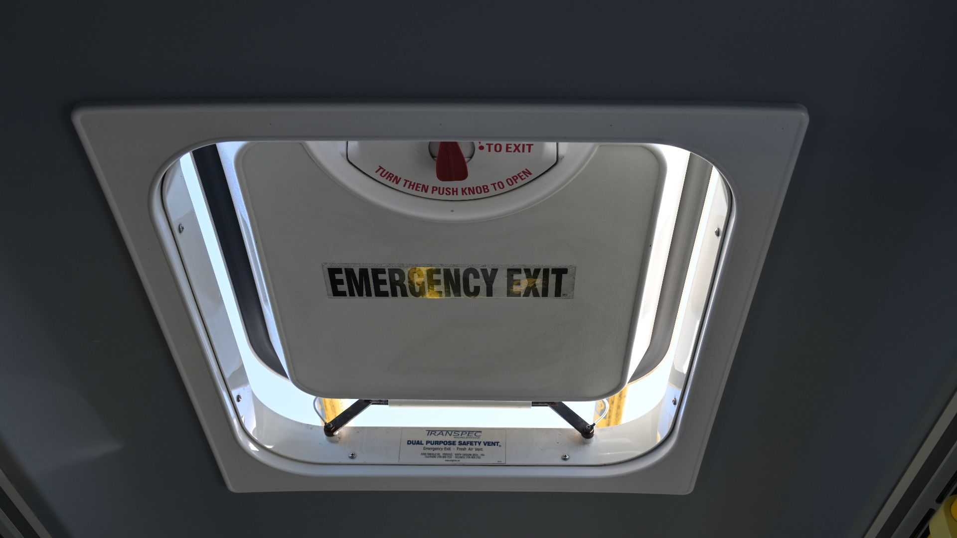 The dual-purpose roof escape hatch/ventilation vent on a SF Muni New Flyer XT40 trolleybus, partly opened for ventilation.