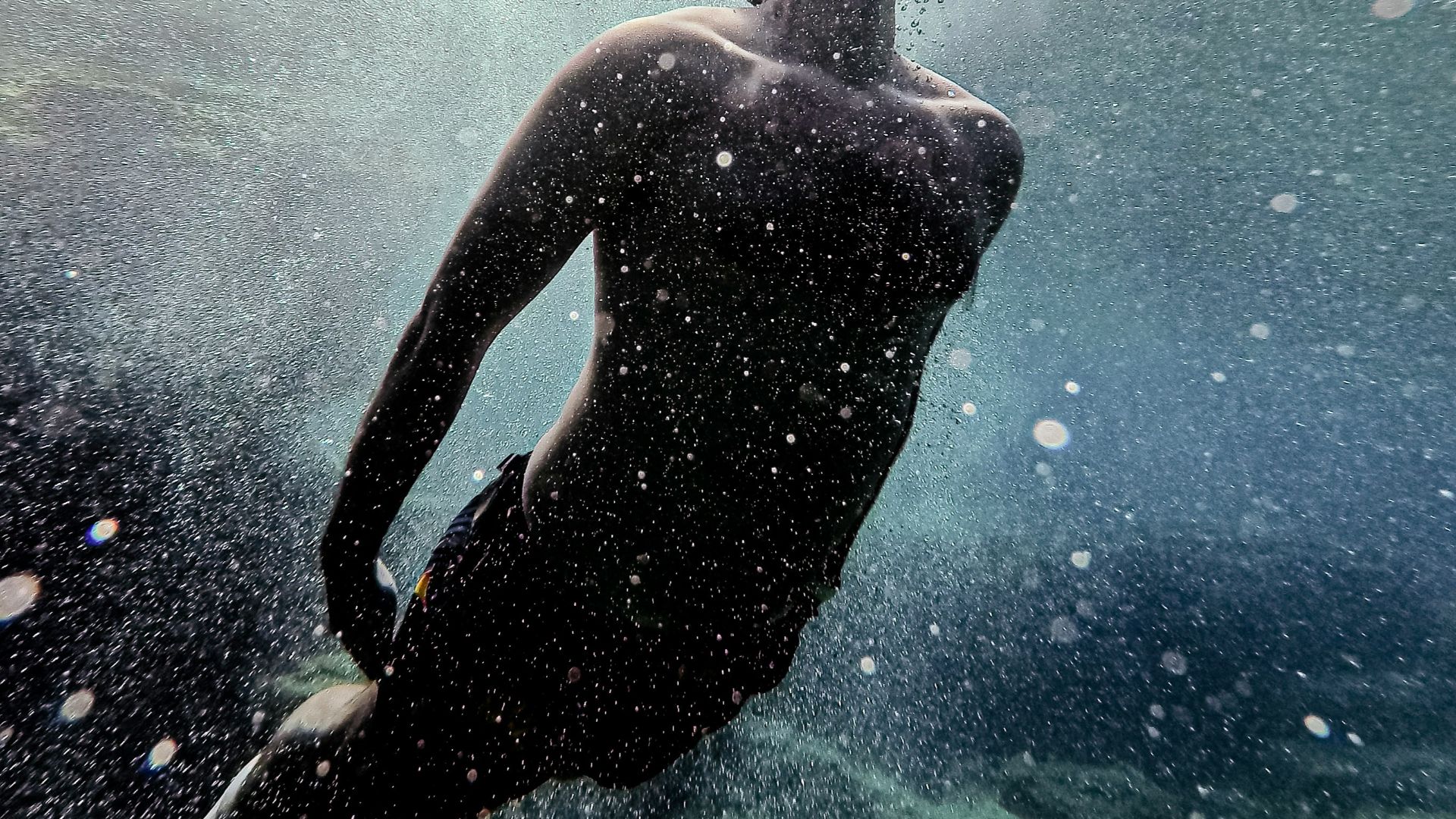 man in water with blue and white lights