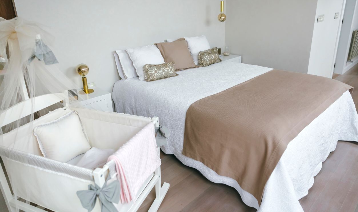 Sober and elegant bedroom with double bed and cot with canopy