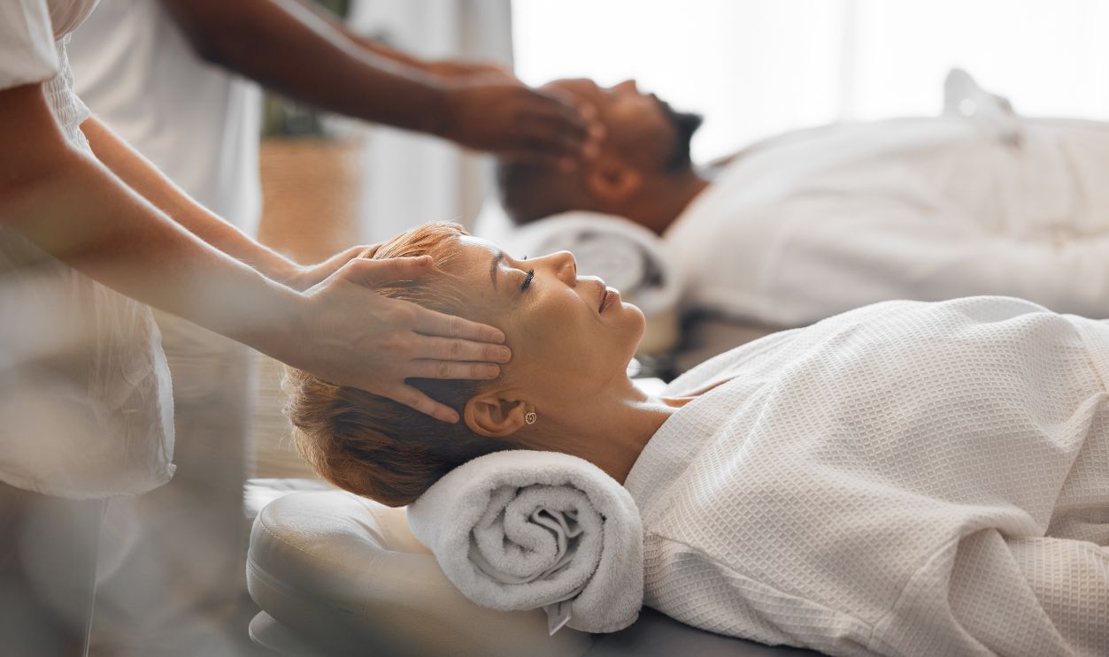 Spa, couple and massage to relax, being peaceful and calm to enjoy retreat treatment for stress relief. Man, woman and massage therapist for wellness, stress free together and quality time on holiday