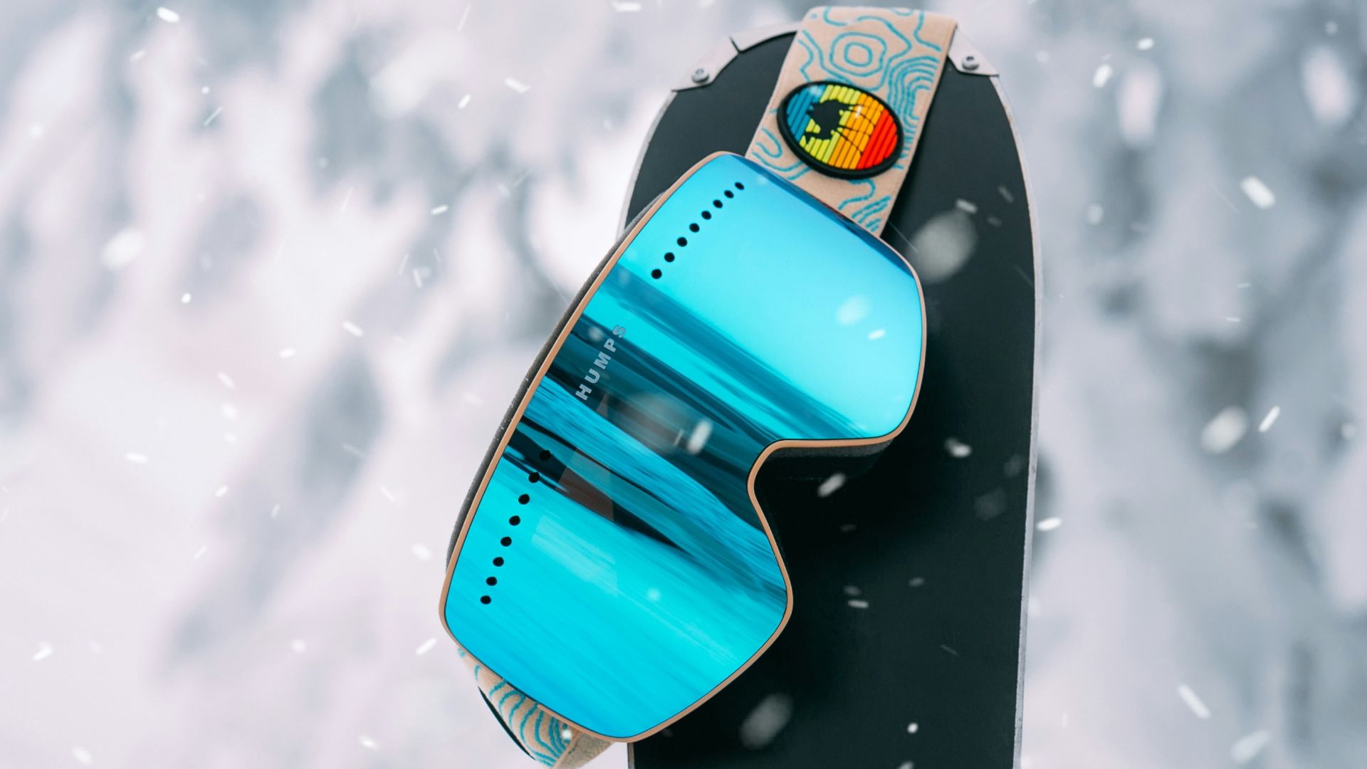 blue and black surfboard on snow covered ground