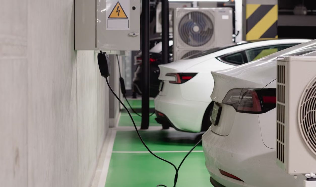 Electric vehicles charging at an indoor station in a modern underground garage