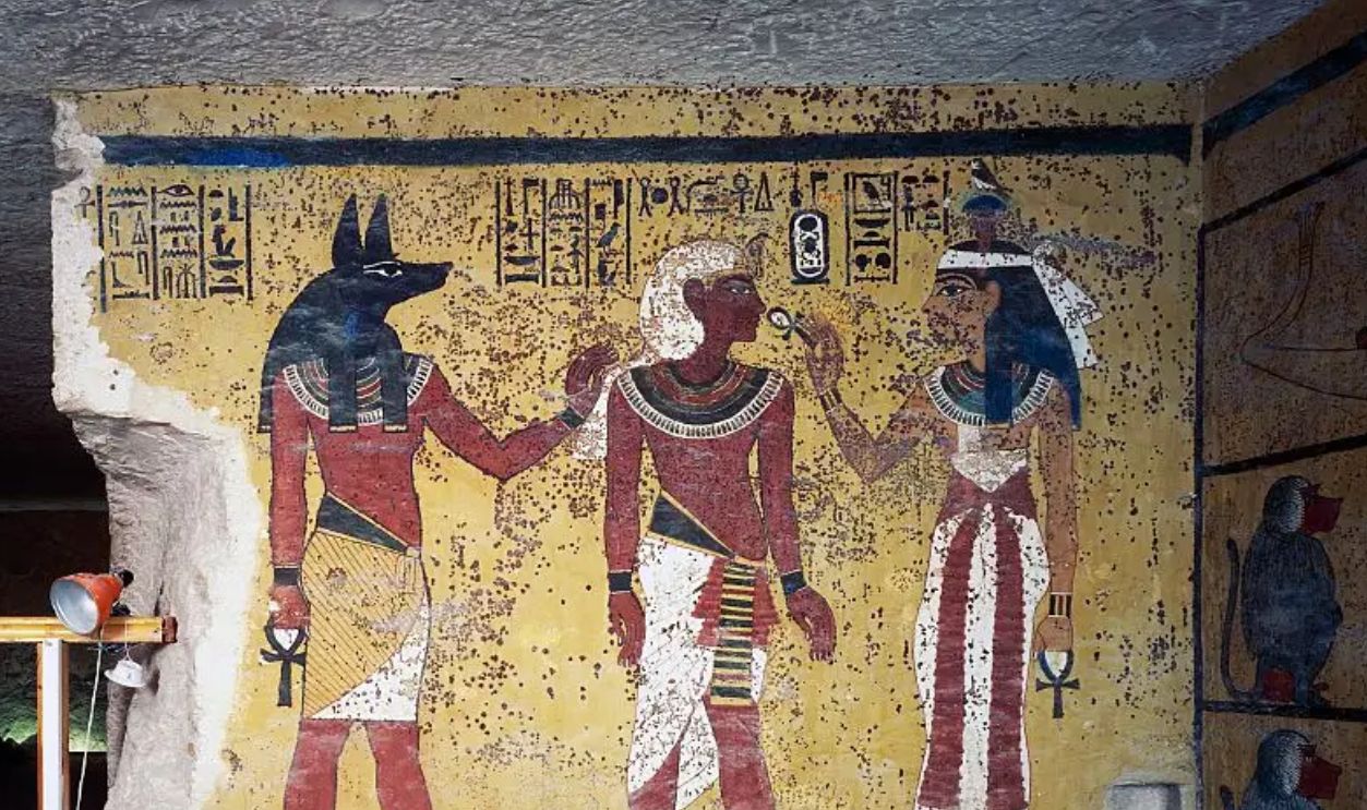 EGYPT - JANUARY 16: Tutankhamun flanked by god Anubis and goddess Hathor, Hathor offering him life with the ankh, Tomb of Tutankhamun, Valley of the Kings, Ancient Thebes, Luxor (UNESCO World Heritage List, 1979). Egypt, XVIII Dynasty, 1347-1338 BC. 