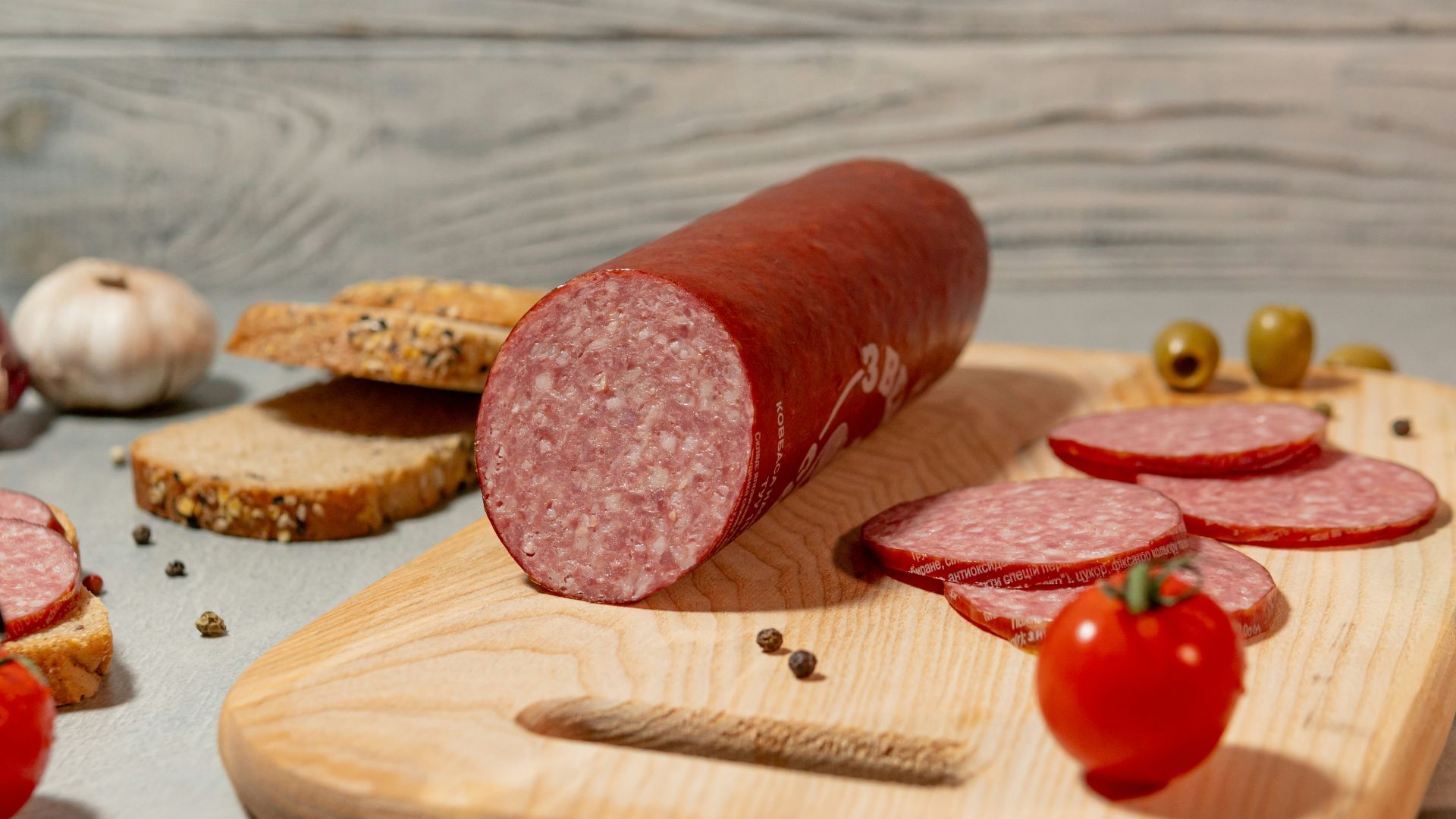Salami with bread, tomatoes, olives, and garlic