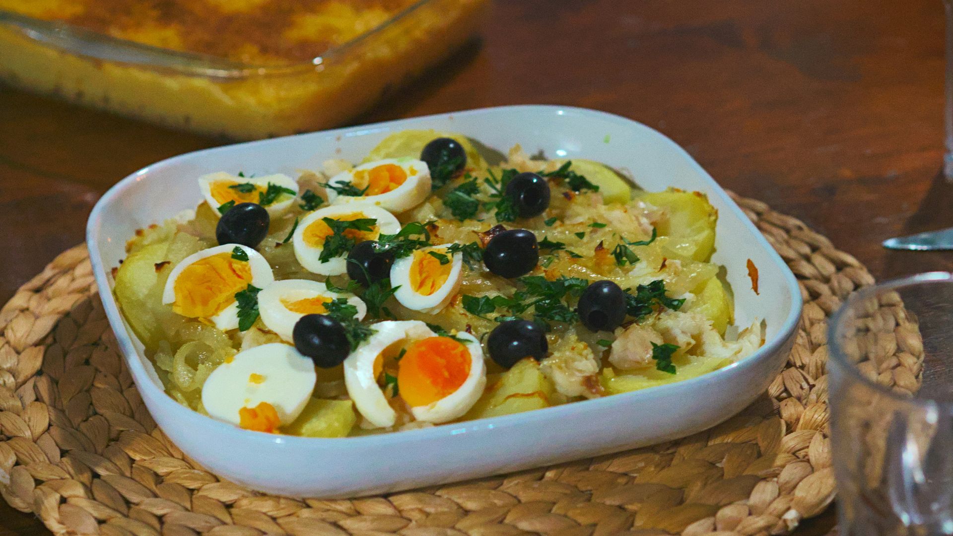 Baked dish with potatoes, eggs, and olives