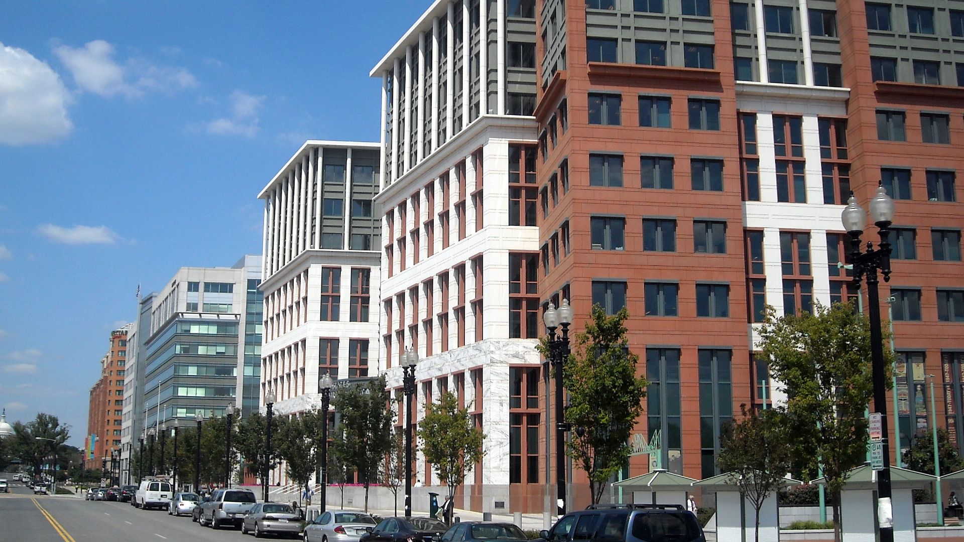 The United States Department of Transportation headquarters, located at 1200 New Jersey Avenue, S.E., in the Navy Yard neighborhood of Washington, D.C.  The dome of the United States Capitol is visible in the background.
