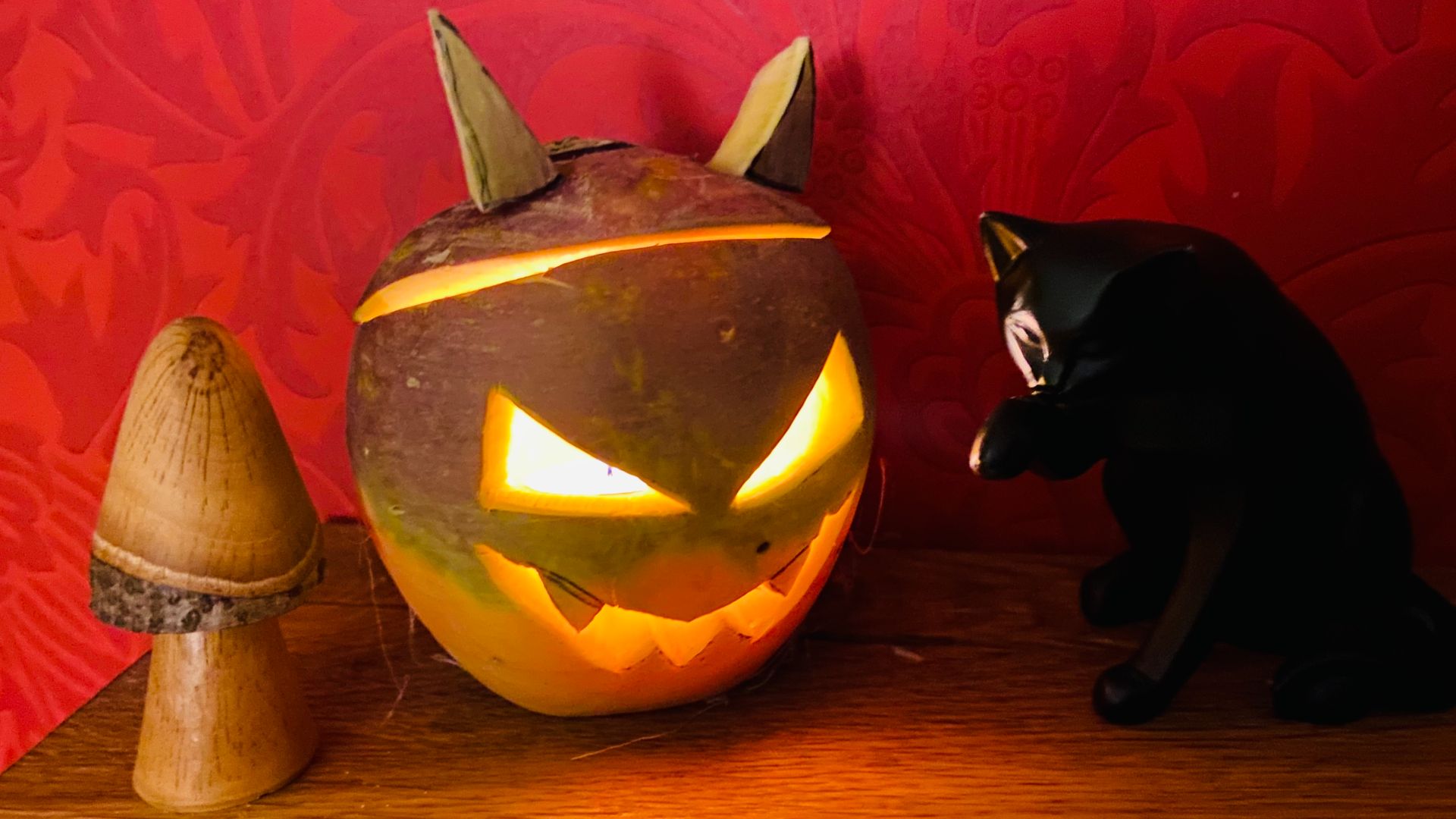 Scottish Halloween tumshie lantern with black cat familiar and wooden toadstool.