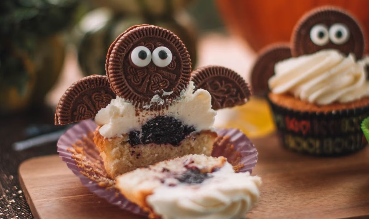 Delicious Halloween cupcakes with Oreo bat decoration perfect for festive celebrations