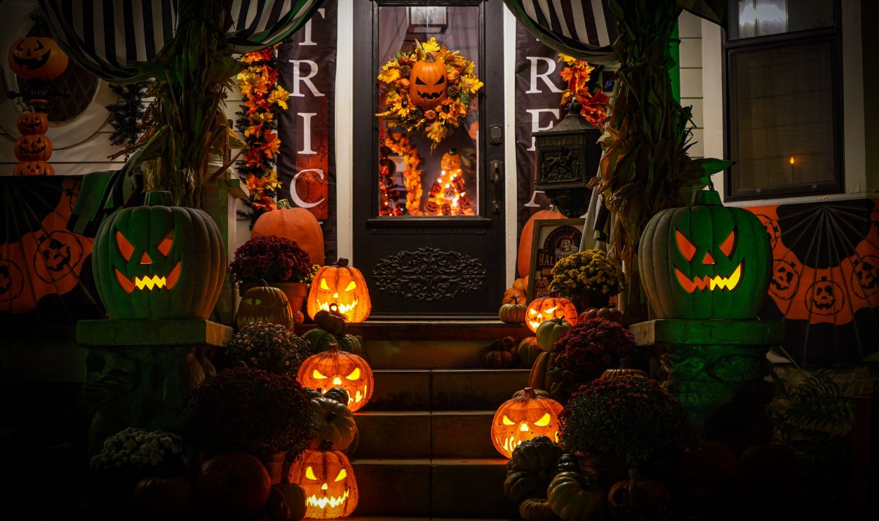Decorated porch with glowing jack-o'-lanterns on Halloween night
