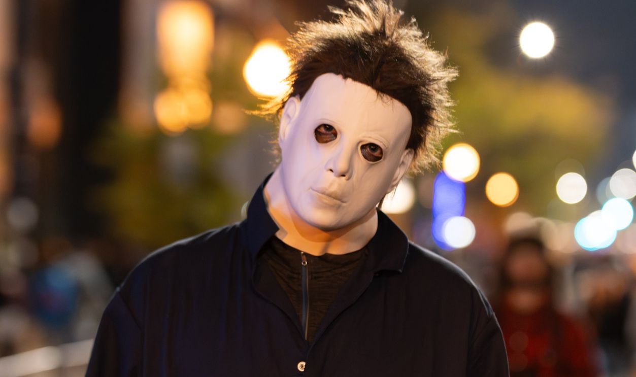 A masked figure participates in the Halloween parade in Chicago. Night street photography