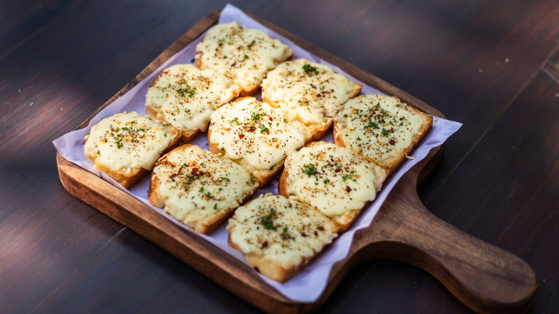 brown and white bread on brown wooden tray