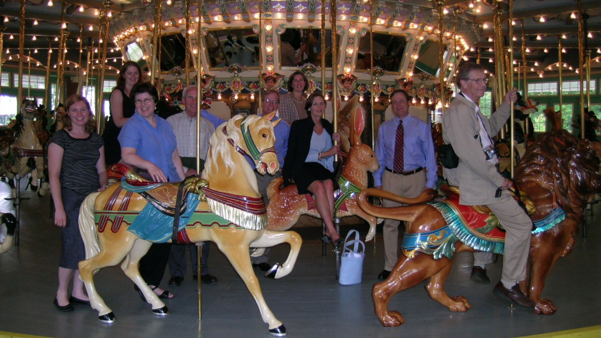 An image of the Preservation Maryland Board of Directors on the carousel at Glen Echo Park. The amusement park opened in the early 1900s, and closed in 1968. It is now managed by the National Park Service. The carousel was the site of a Civil Rights sit-i