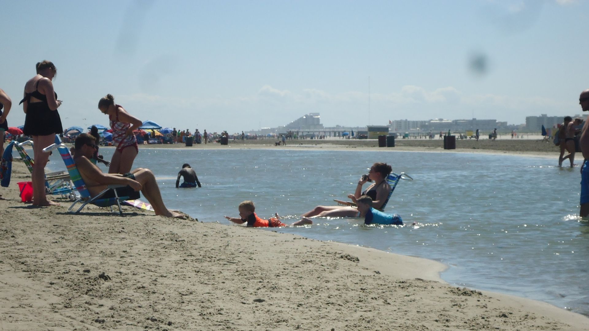 The Atlantic Ocean is to the left (not shown) -- the people are on a strip of sand between the tidal pool (shown) and the ocean. The pool was only about a foot deep in places without waves.