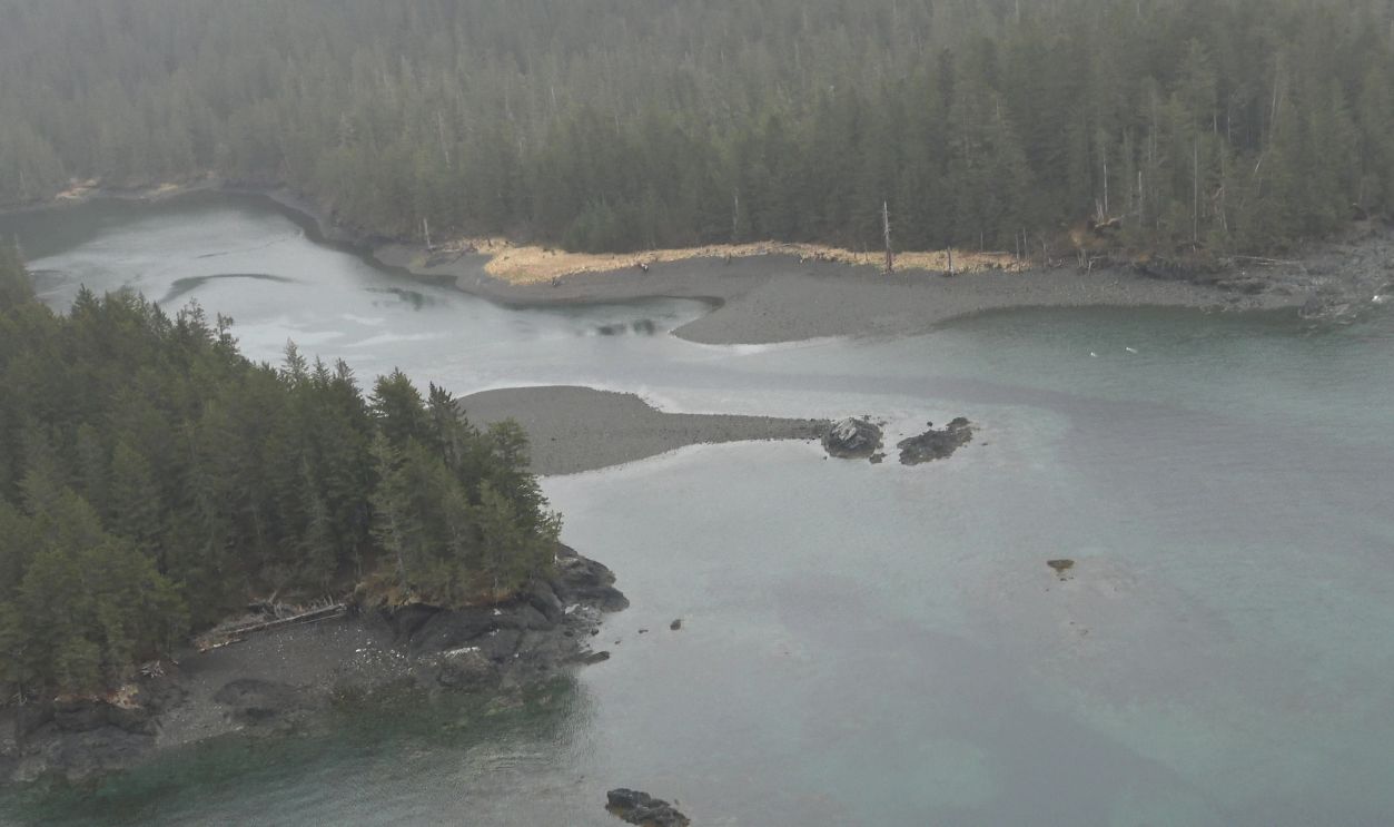 Captured from the back seat of a helicopter, these aerial photographs document the remote and abandoned coastal settlement of Portlock, Alaska (also known as Port Chatham). Located on the southern tip of the Kenai Peninsula approximately 42 miles from Homer, the site is accessible only by boat or aircraft. The images show the rugged shoreline, dense forest, and scattered remnants of the former fishing village, which was deserted in the mid‑20th century. The photos were taken in May 2026 during a dark, stormy weather system with heavy rain, low visibility, and strong winds. These challenging flight conditions contribute to the dramatic atmosphere of the images, emphasizing the isolation of the location and the harsh environment surrounding it. While the town is associated with local legends involving unexplained disappearances, the photographs focus on the real, observable landscape: the coastline, the abandoned structures, and the wild terrain that defines this part of Alaska. This series provides a rare aerial perspective of a difficult‑to‑reach historic site, highlighting both the natural beauty and the desolate character of the Portlock area.