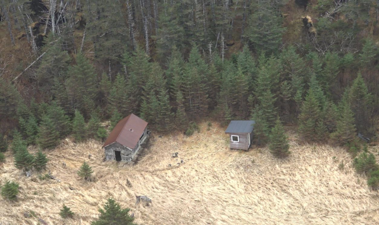 Captured from the back seat of a helicopter, these aerial photographs document the remote and abandoned coastal settlement of Portlock, Alaska (also known as Port Chatham). Located on the southern tip of the Kenai Peninsula approximately 42 miles from Homer, the site is accessible only by boat or aircraft. The images show the rugged shoreline, dense forest, and scattered remnants of the former fishing village, which was deserted in the mid‑20th century. The photos were taken in May 2026 during a dark, stormy weather system with heavy rain, low visibility, and strong winds. These challenging flight conditions contribute to the dramatic atmosphere of the images, emphasizing the isolation of the location and the harsh environment surrounding it. While the town is associated with local legends involving unexplained disappearances, the photographs focus on the real, observable landscape: the coastline, the abandoned structures, and the wild terrain that defines this part of Alaska. This series provides a rare aerial perspective of a difficult‑to‑reach historic site, highlighting both the natural beauty and the desolate character of the Portlock area.