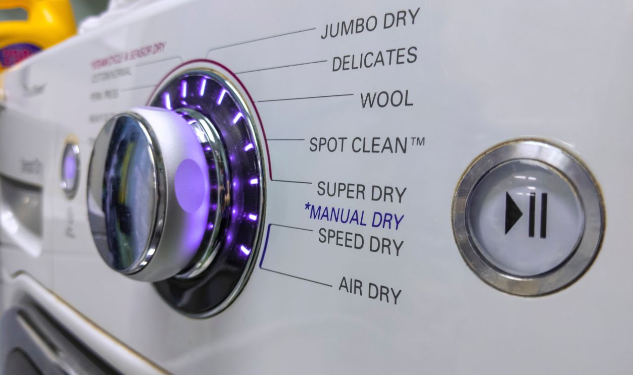 Close up of a knob on a clothing dryer control panel