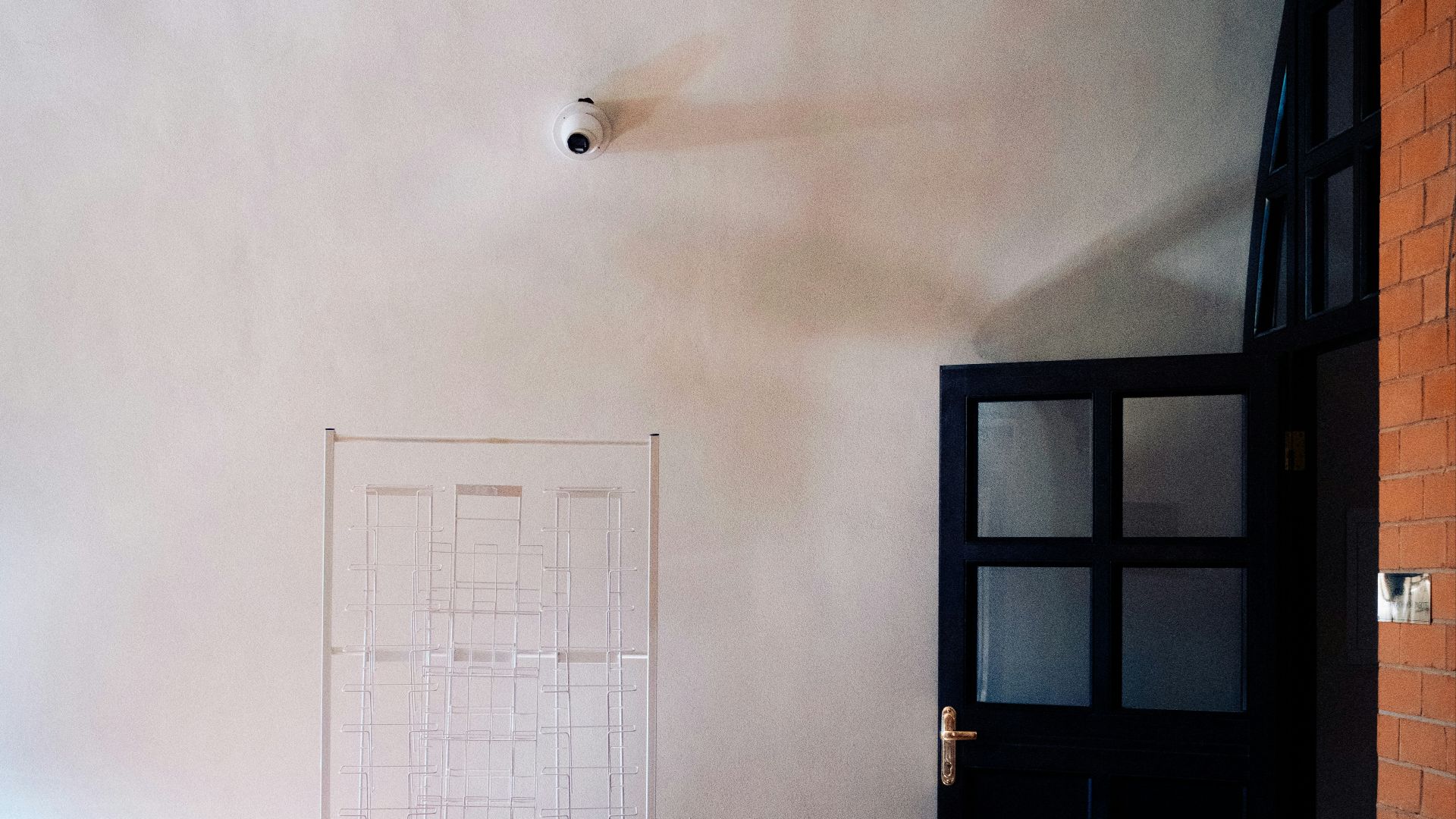 Open door with rainbow light on a white wall