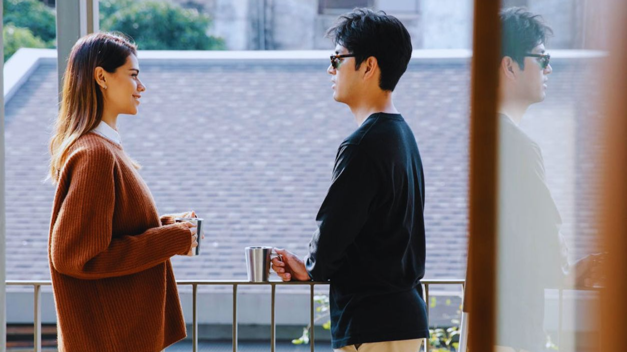 Photo of Man and Woman Chilling in the Balcony