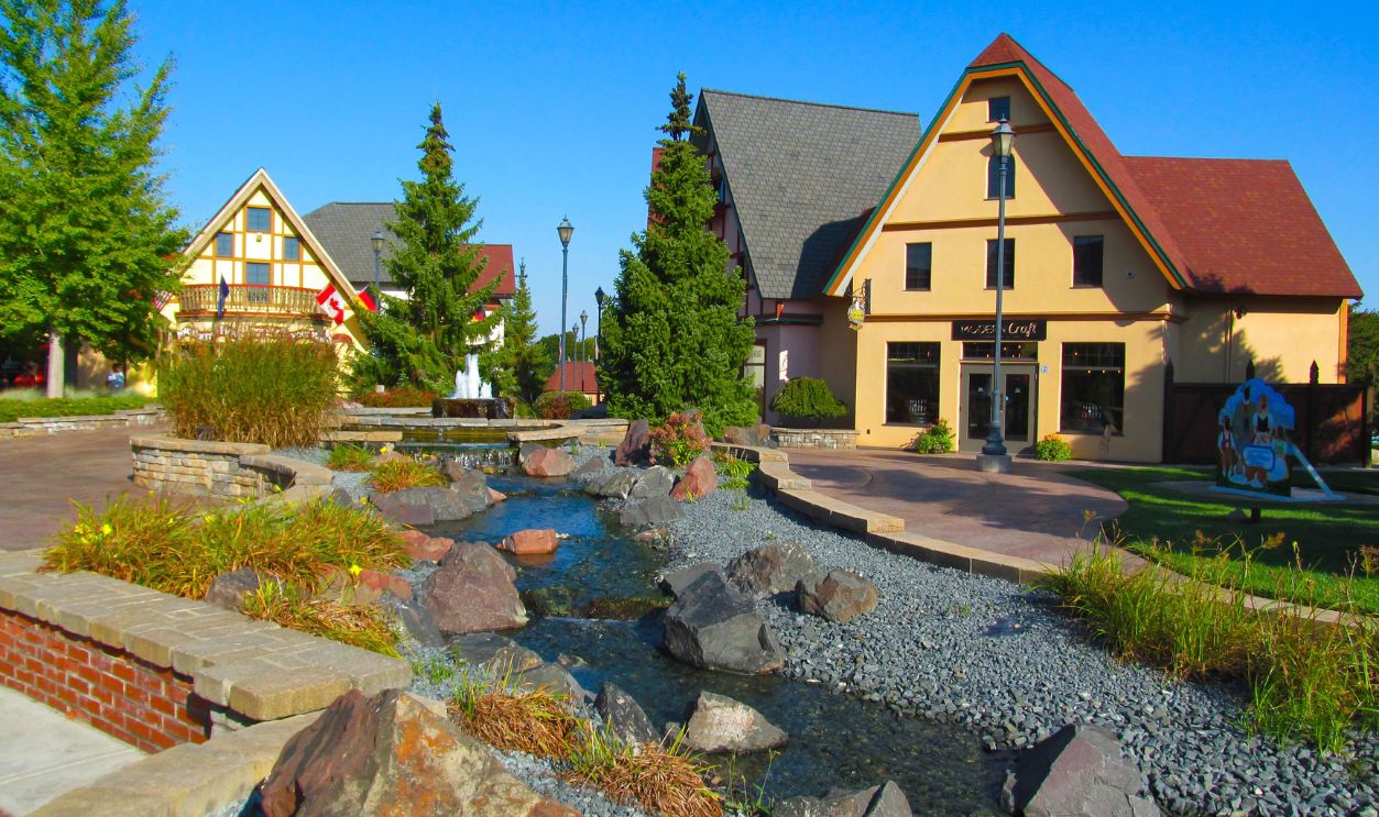FRANKENMUTH, MI, USA - September 17, 2017. Beautiful architecture in German style and decorative landscape city creek. Nice view of amazing tourist town Frankenmuth in Michigan  on blue sky background