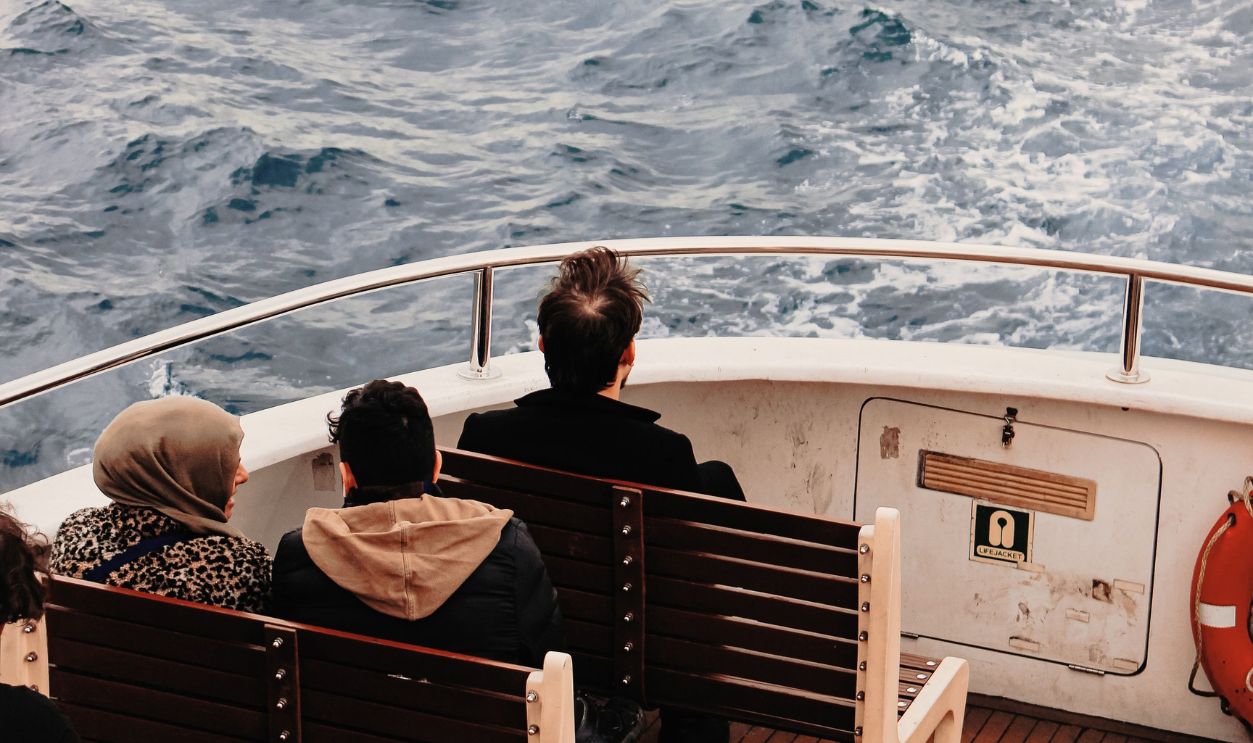 A serene boat ride with passengers enjoying the ocean view