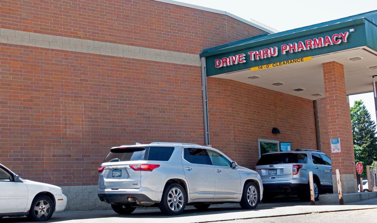 ST PAUL, MINNESOTA USA - JULY 18, 2020: Cars are lined up to pick up pharmaceuticals in the drive through at Walgreens. 