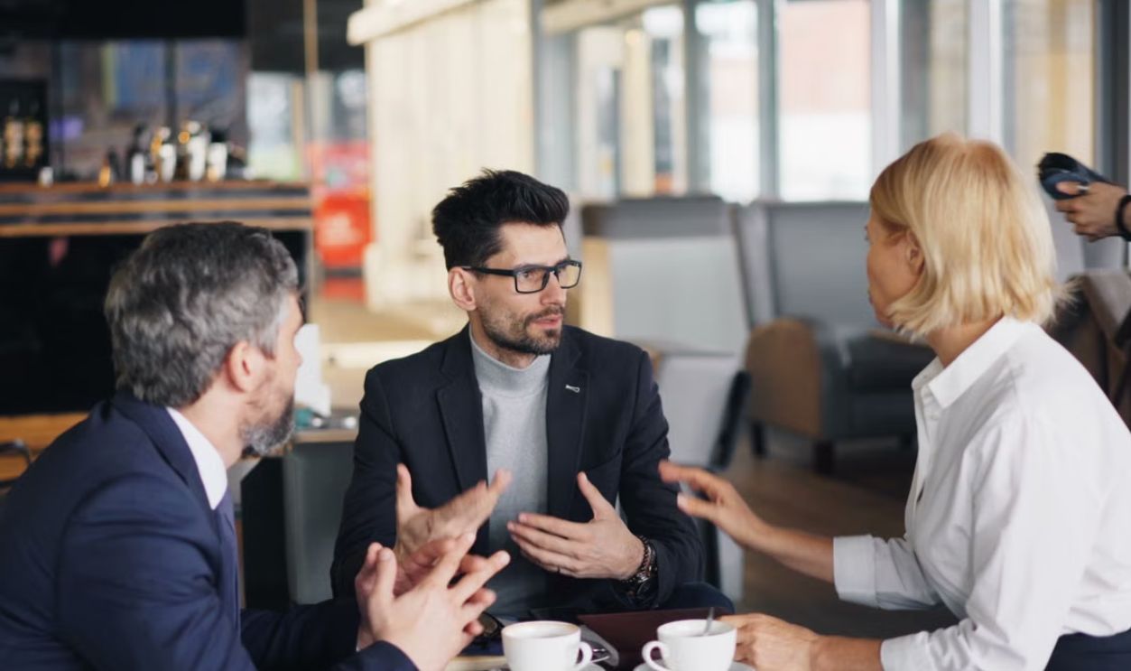 Colleagues having a strategic discussion over coffee in a stylish cafe