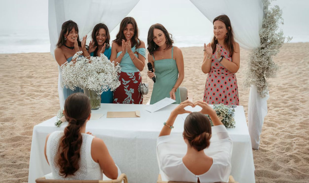 People celebrating a wedding ceremony on a beach