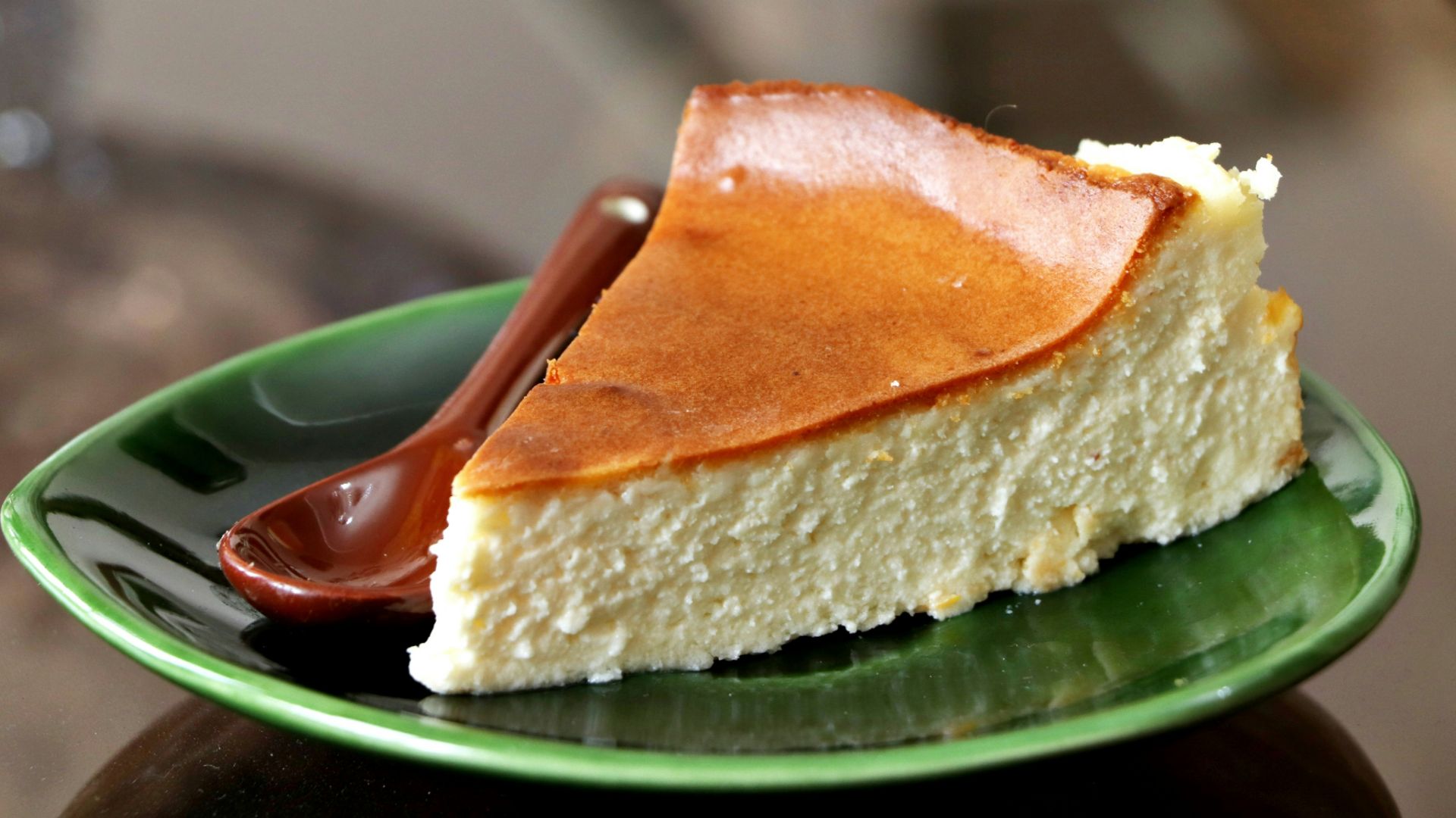 a piece of cheesecake on a green plate
