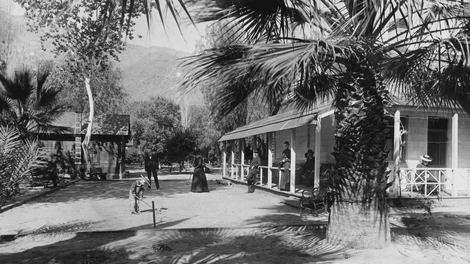 First hotel in Palm Springs, ca.1901
Photograph of a small group of people playing croquet at Dr. Welwood Murray's hotel in Palm Springs, ca.1901. This was the first hotel in Palm Springs. Also visible is the south porch. Numerous trees surround the hotel
