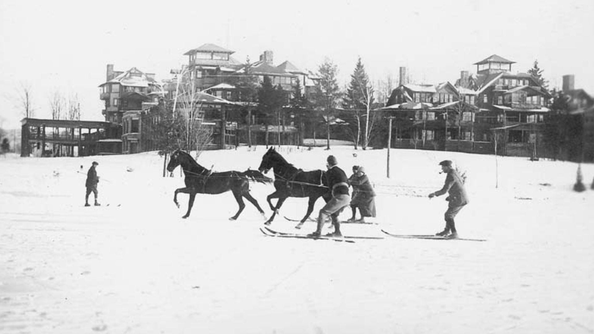 In the background the Lake Placid Club (New York State). In the foreground a group ski joring
