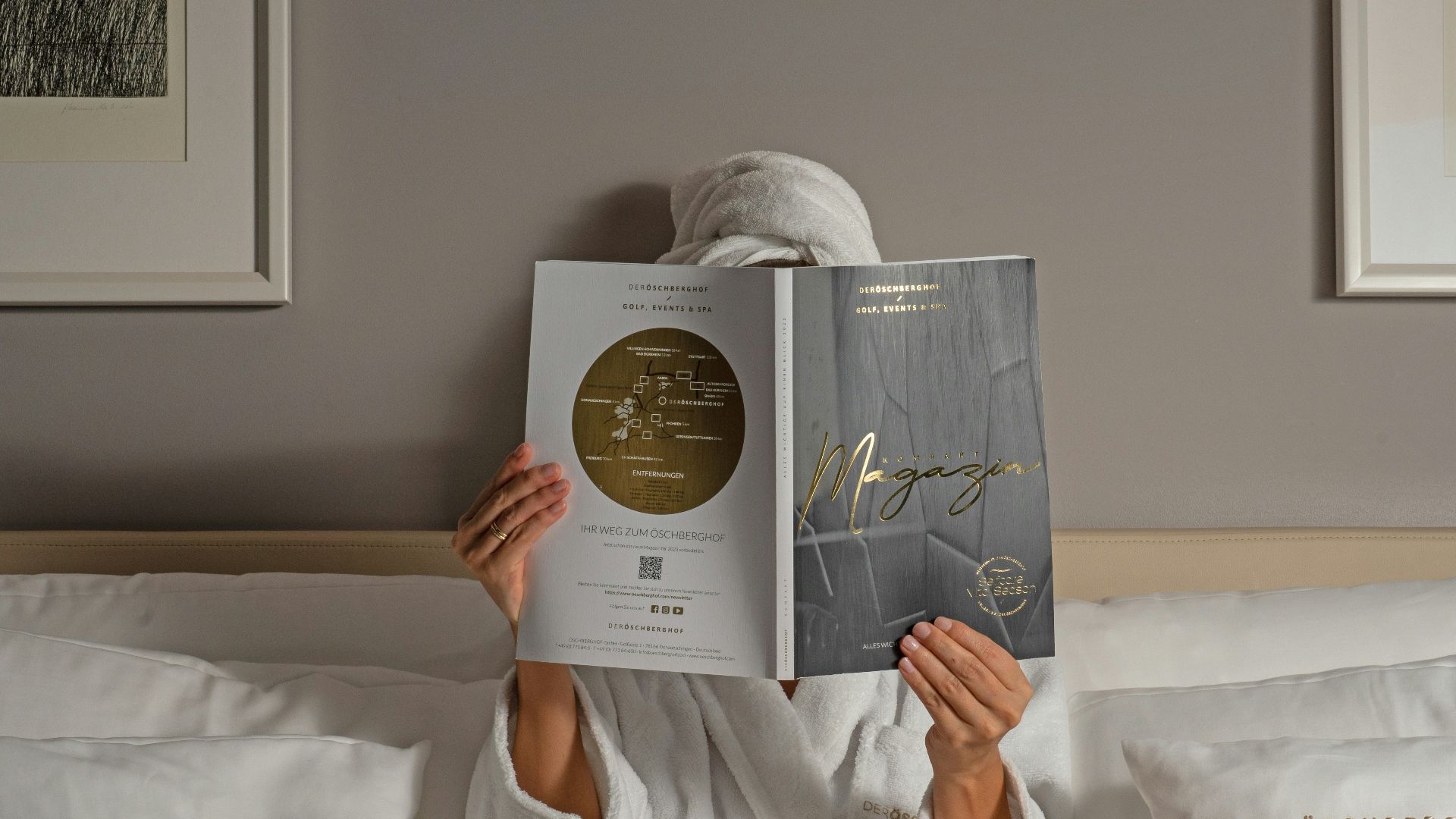 a person reading a book on a bed
