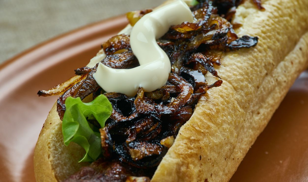 Caramelized Beer Onions and Cheddar Bratwurst close up