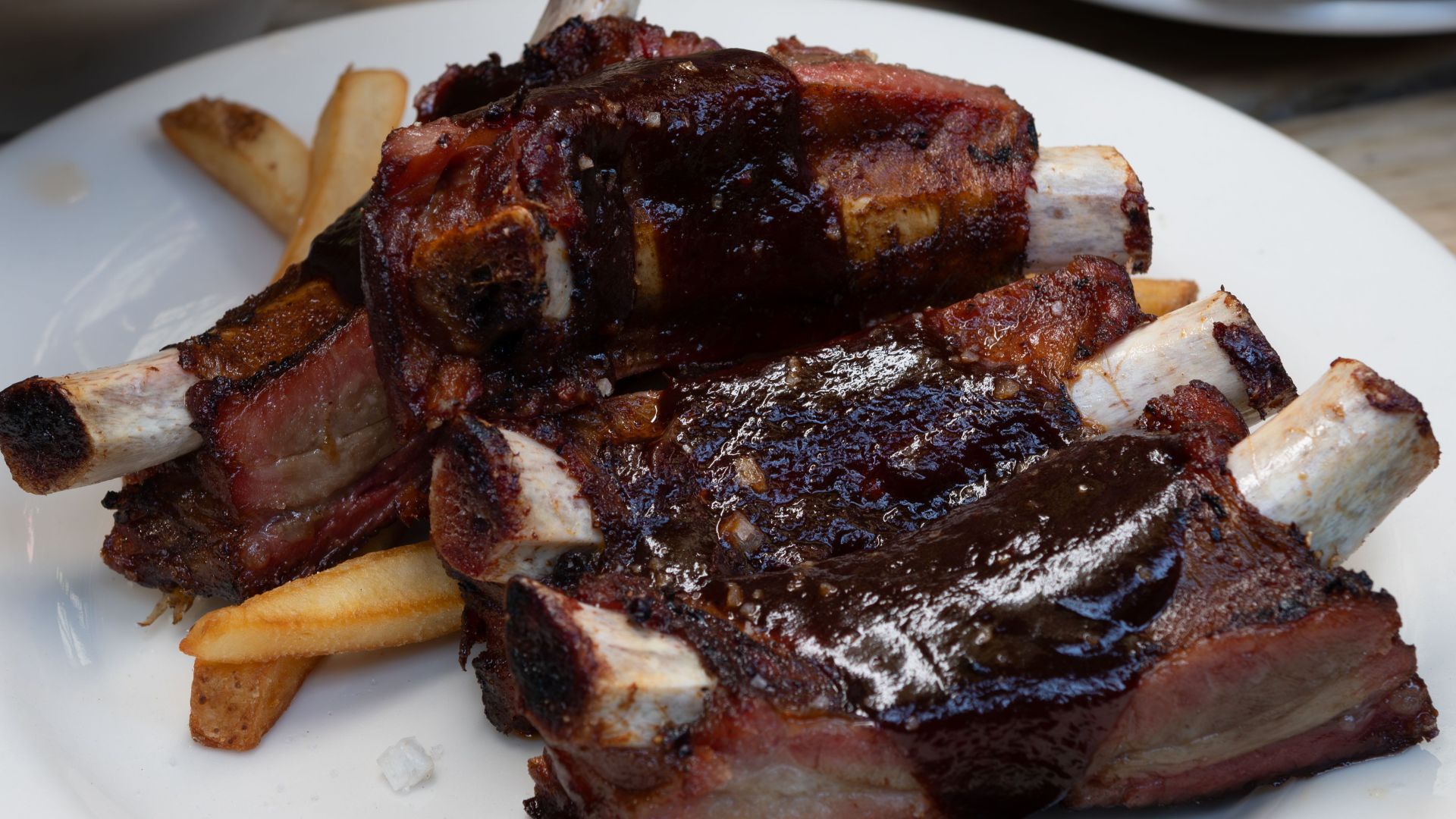Savor these juicy barbecue ribs drenched in sauce, perfect for a delightful meal.
