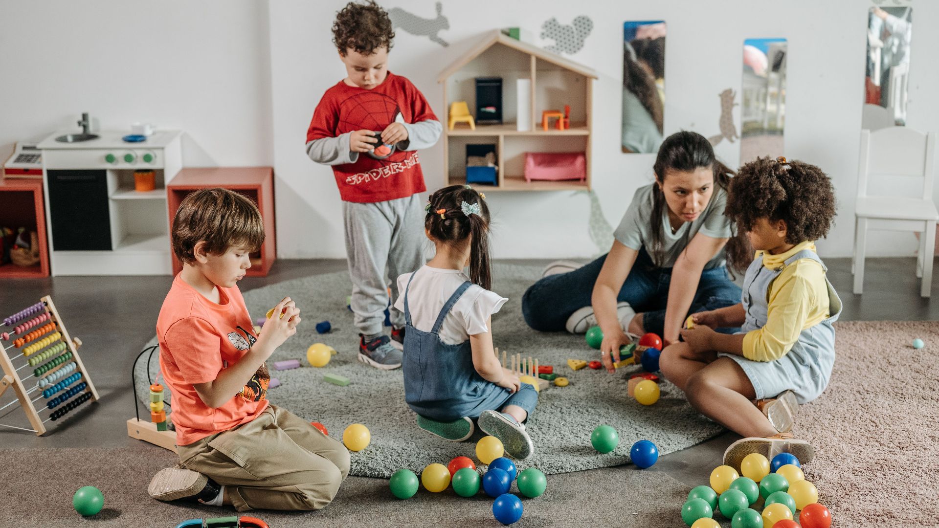 Young children and a teacher engaging in play and learning activities in a preschool setting.