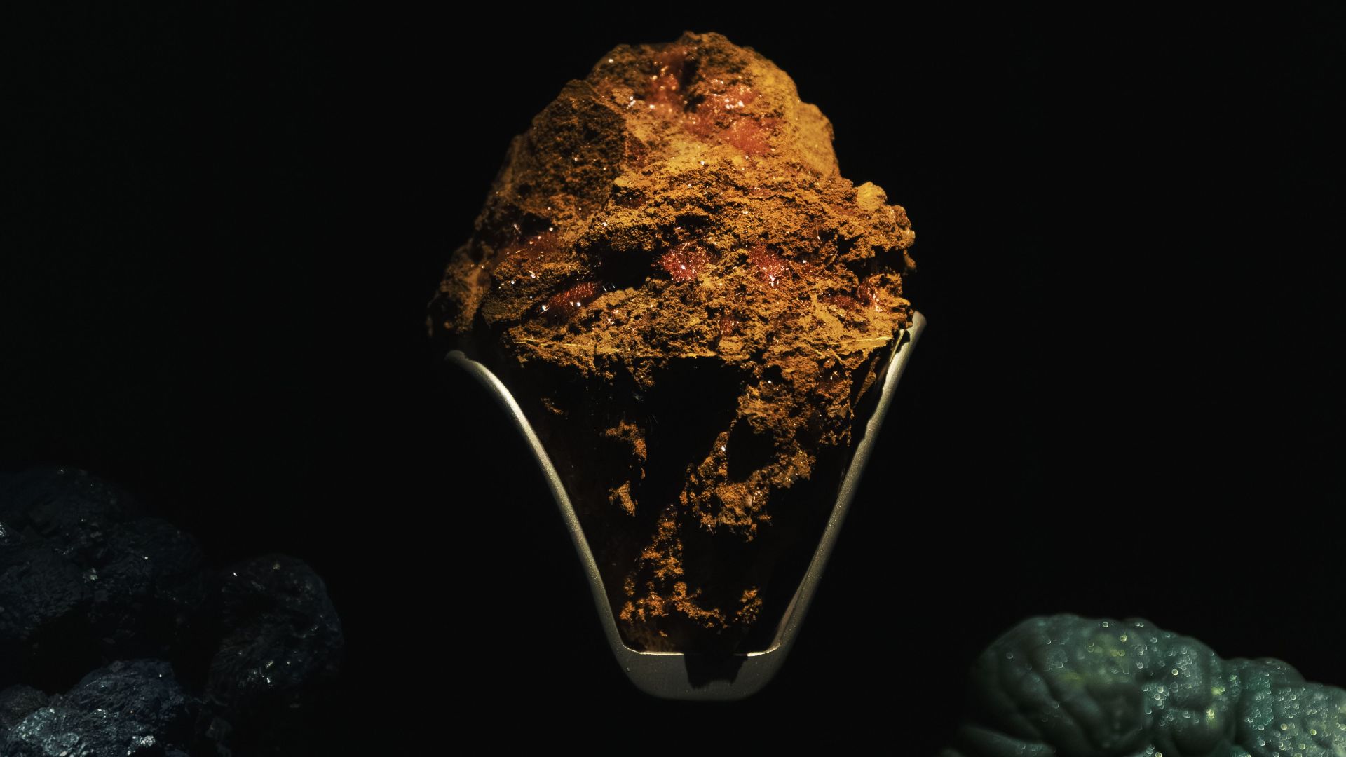 A striking display of minerals and rocks with dramatic lighting and rich textures.