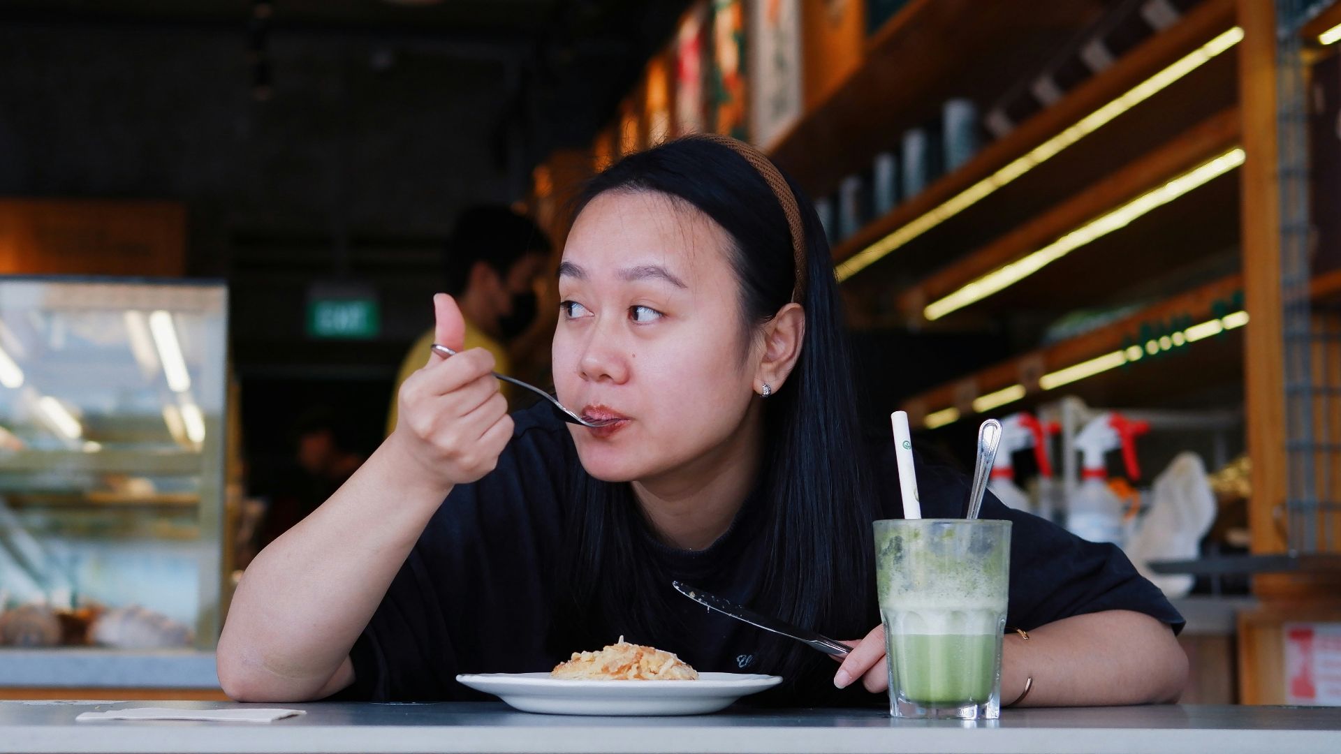 A woman eating food at a cafe