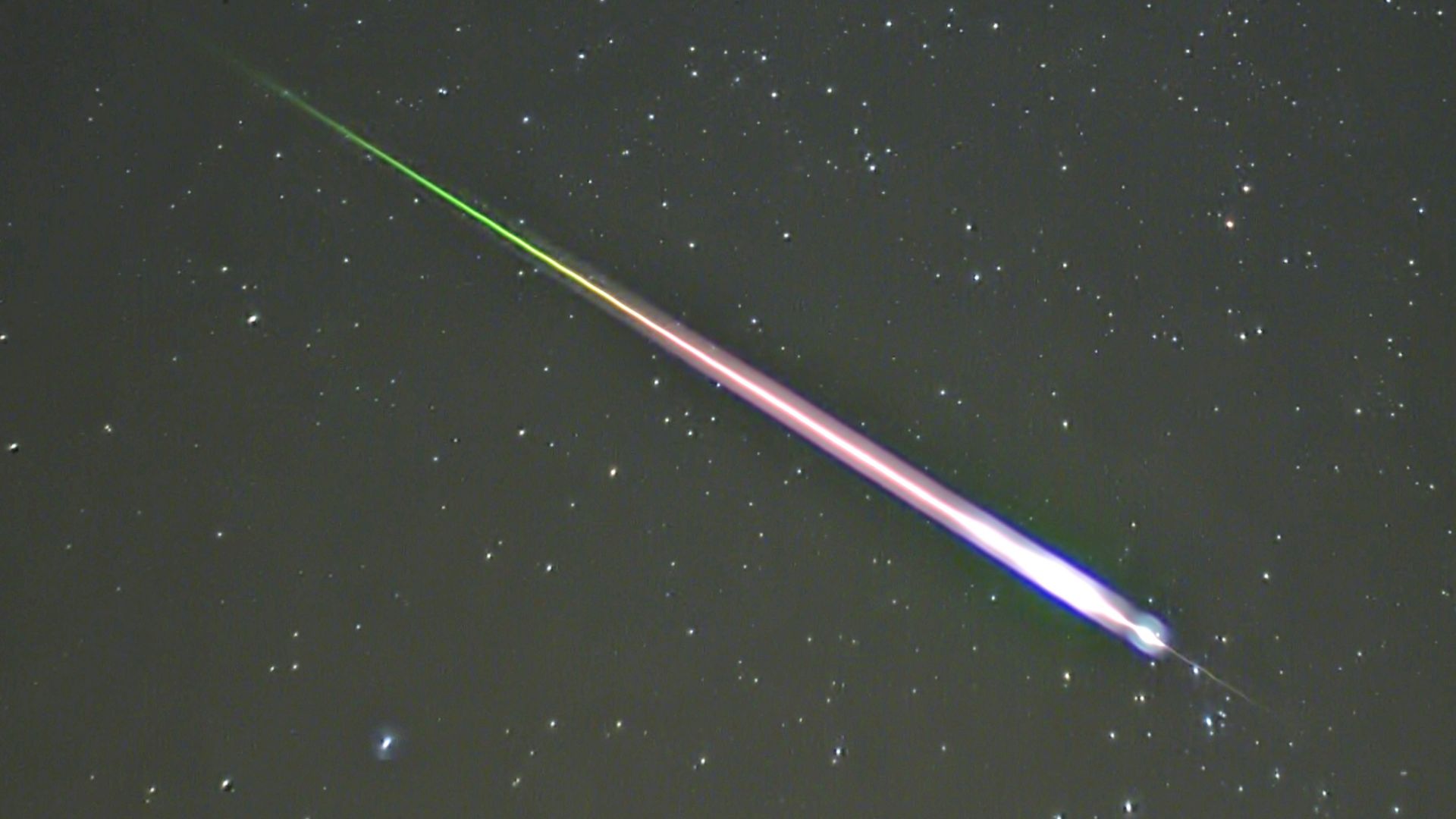 A meteor during the peak of the 2009 Leonid Meteor Shower. The photograph shows the meteor, afterglow, and wake as distinct components.