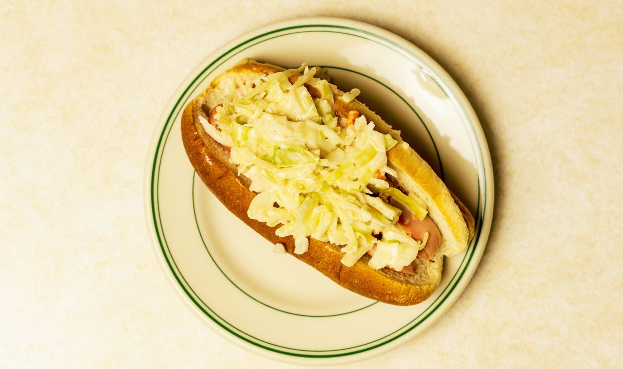 Hot dog with coleslaw on a plate