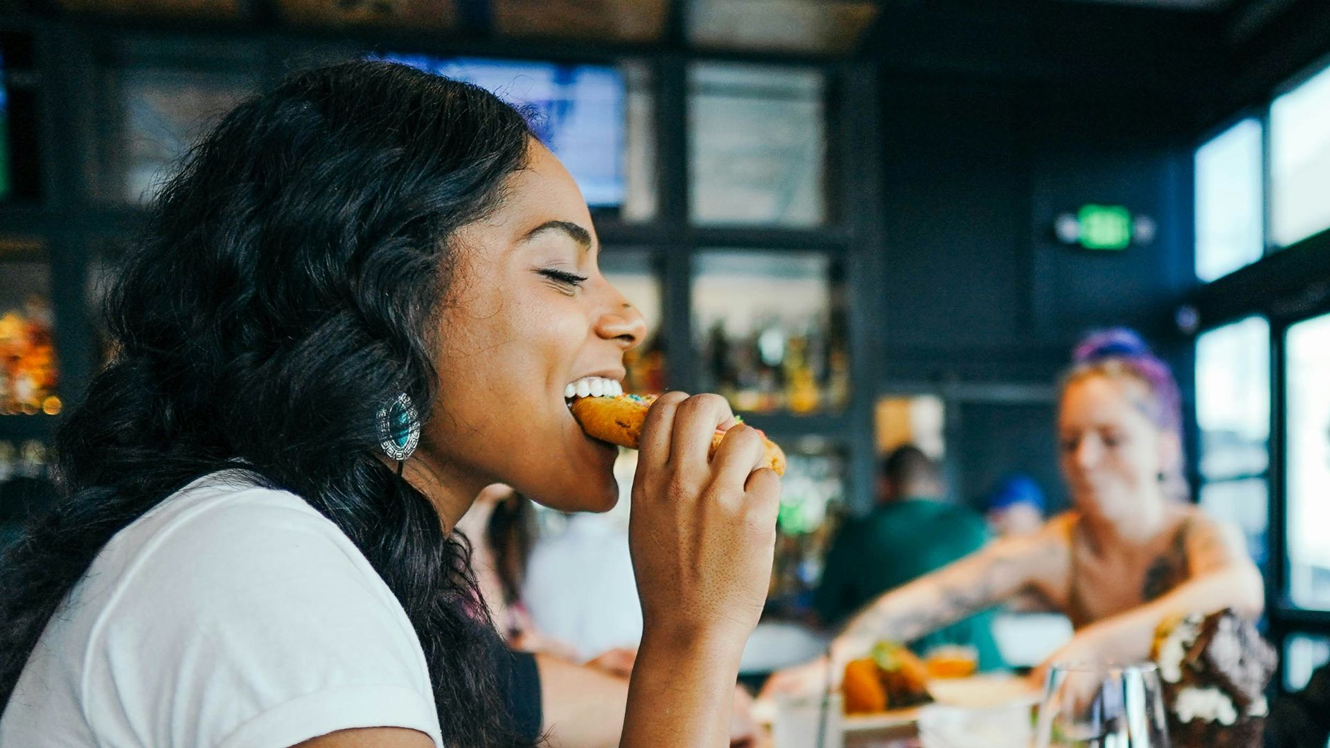 woman in white shirt eating